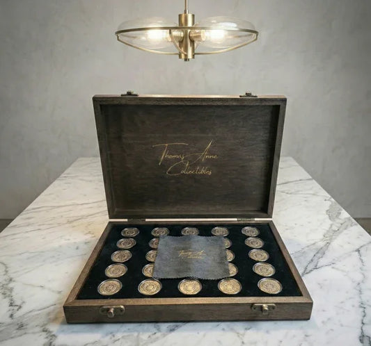 Handcrafted mahogany coin archive case with deep walnut finish and brass latches, featuring 25 slots for Australian two dollar coins on a marble surface.