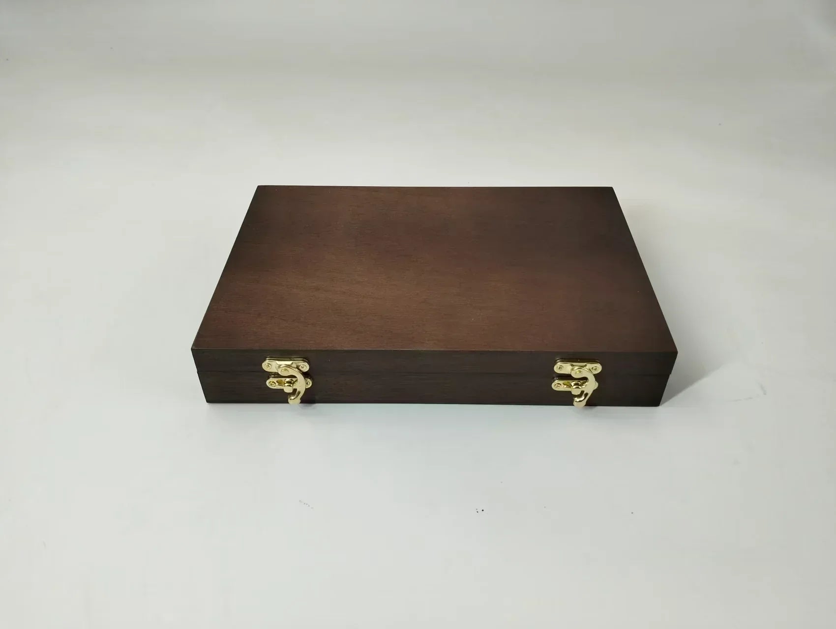Closed handcrafted mahogany archive case with a walnut finish and gold-toned brass hardware, designed for premium coin collection and display.