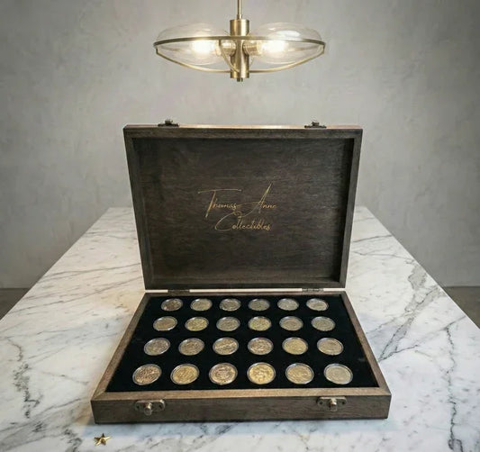 Handcrafted mahogany coin archive case with deep walnut finish and brass latches, featuring 24 slots for Australian one dollar coins on a marble surface.
